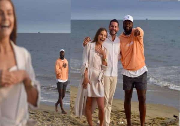 בזמן שקיעה על חוף-הים בדיוק ברגע הצעת הנישואים אגדת ה-NBA טייל על החוף, נכנס בטעות לתמונה והפתיע את הזוג הנרגש